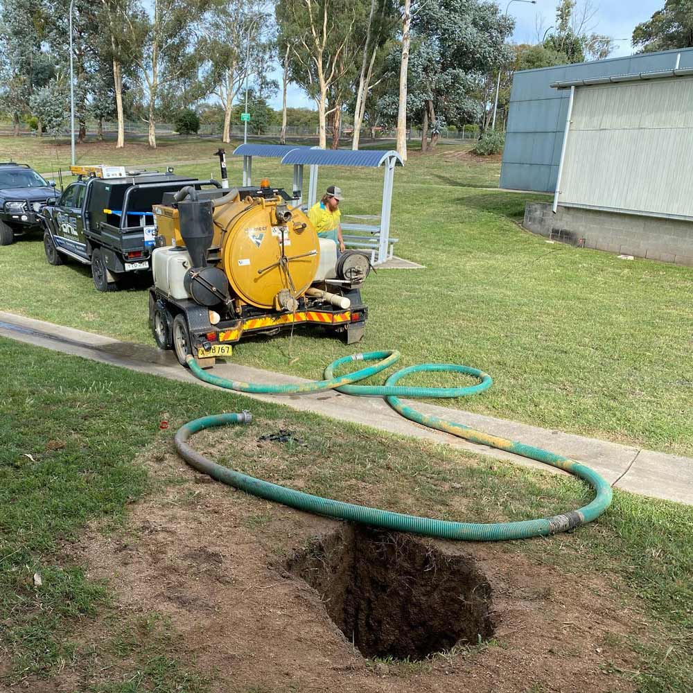 A Vacuum Truck is Pumping Water Into a Hole in the Ground — One Group Industries Pty Ltd in Bathurst, NSW