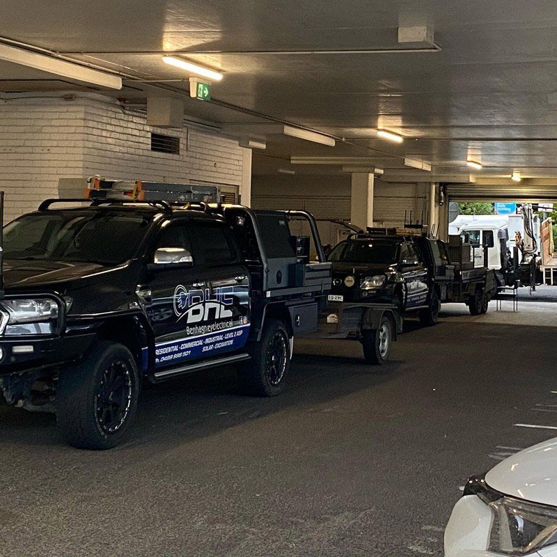 A Row of Trucks Are Parked in a Parking Garage — One Group Industries Pty Ltd in Bathurst, NSW