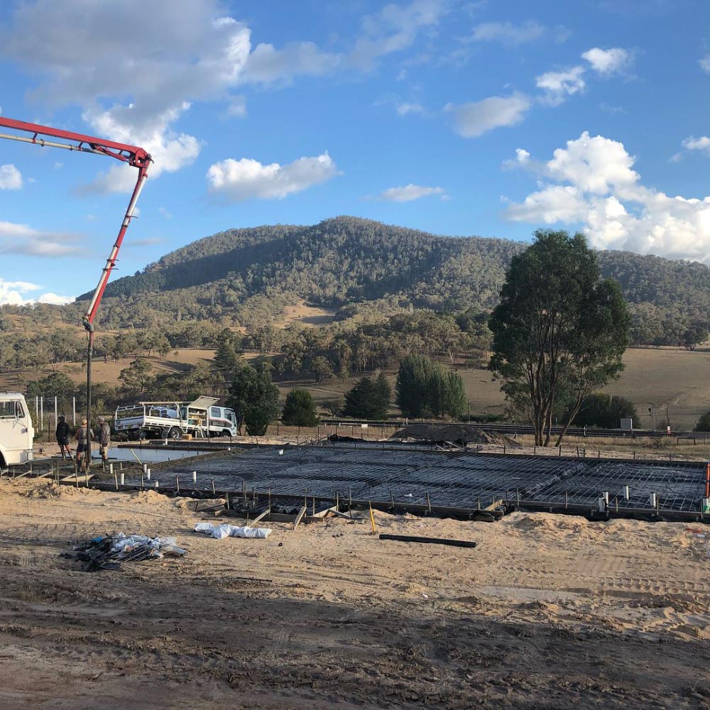 Concrete being poured for a foundation at a construction site in a rural area — One Group Industries Pty Ltd in Bathurst, NSW