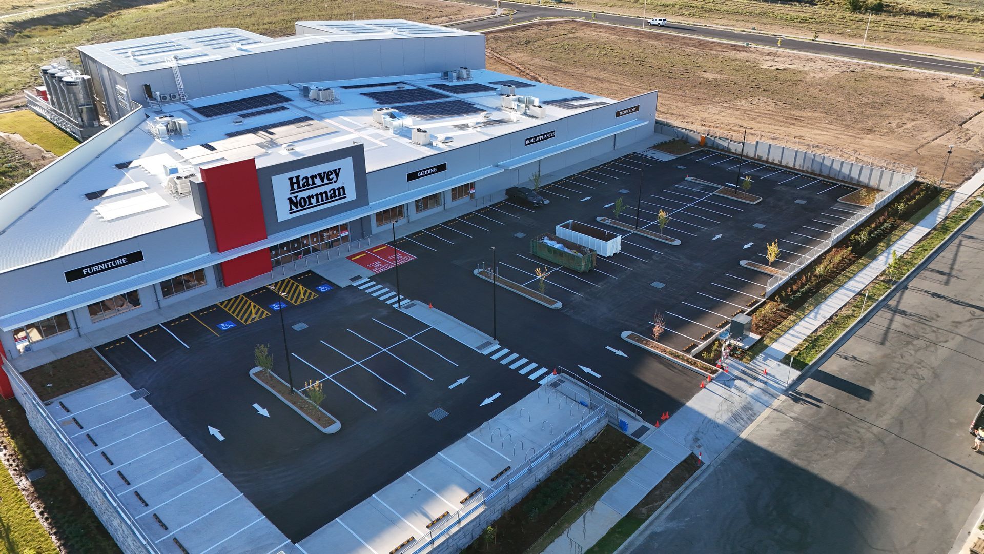 A Pneumatic Tire Roller Compacts Newly Laid Black Asphalt — One Group Industries Pty Ltd in Bathurst, NSW
