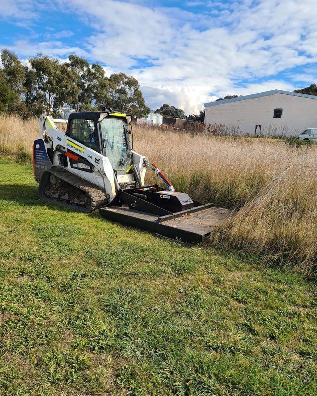 A Bulldozer is Cutting Grass in a Field — One Group Industries Pty Ltd in Bathurst, NSW