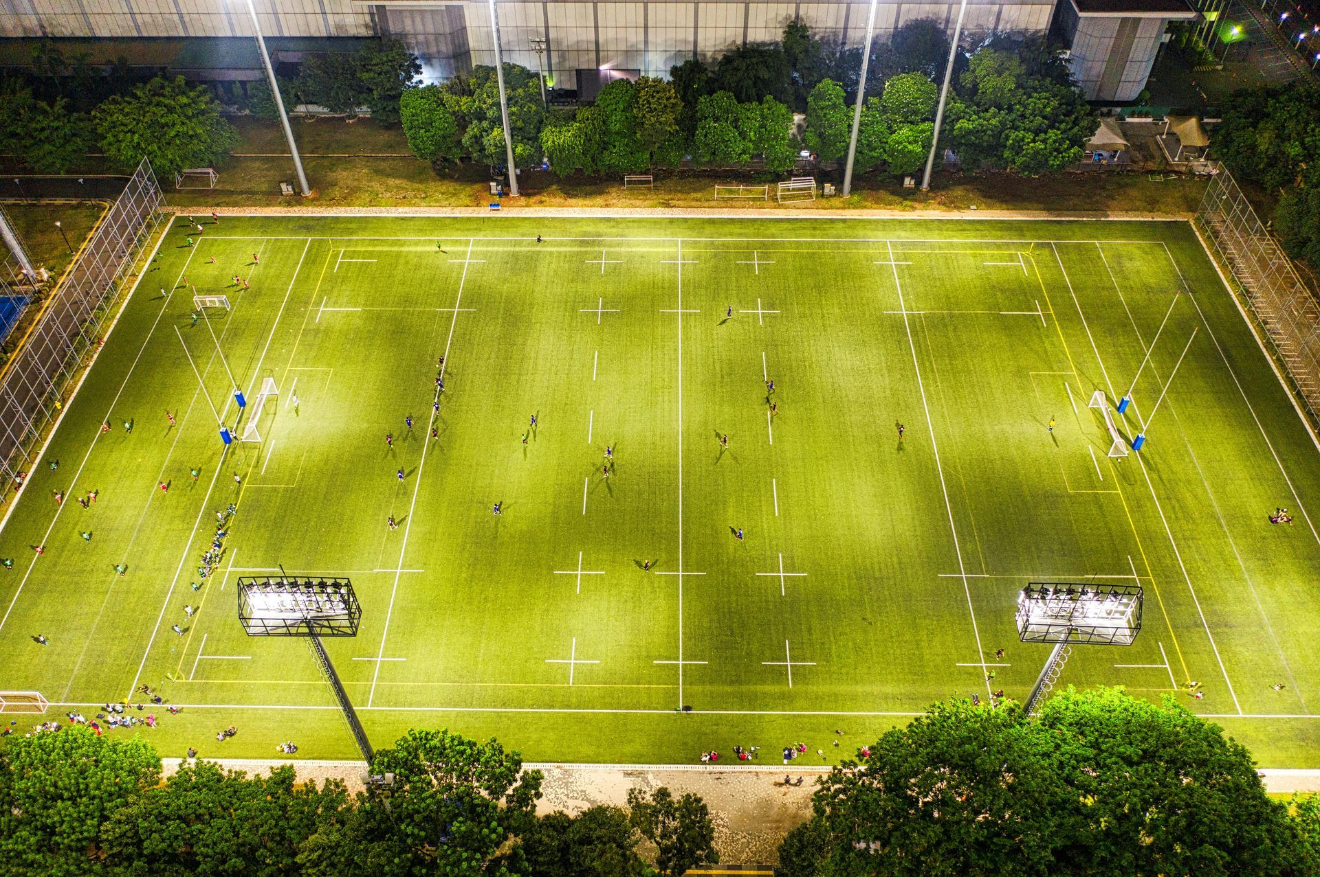 Aerial view of a rugby field lit by floodlights at night — One Group Industries Pty Ltd in Bathurst, NSW