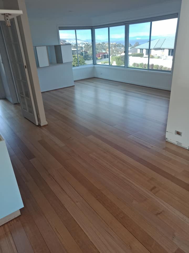 An Empty Room With Polished Light Wood Floors — Finer Floors In Sandy Bay, TAS