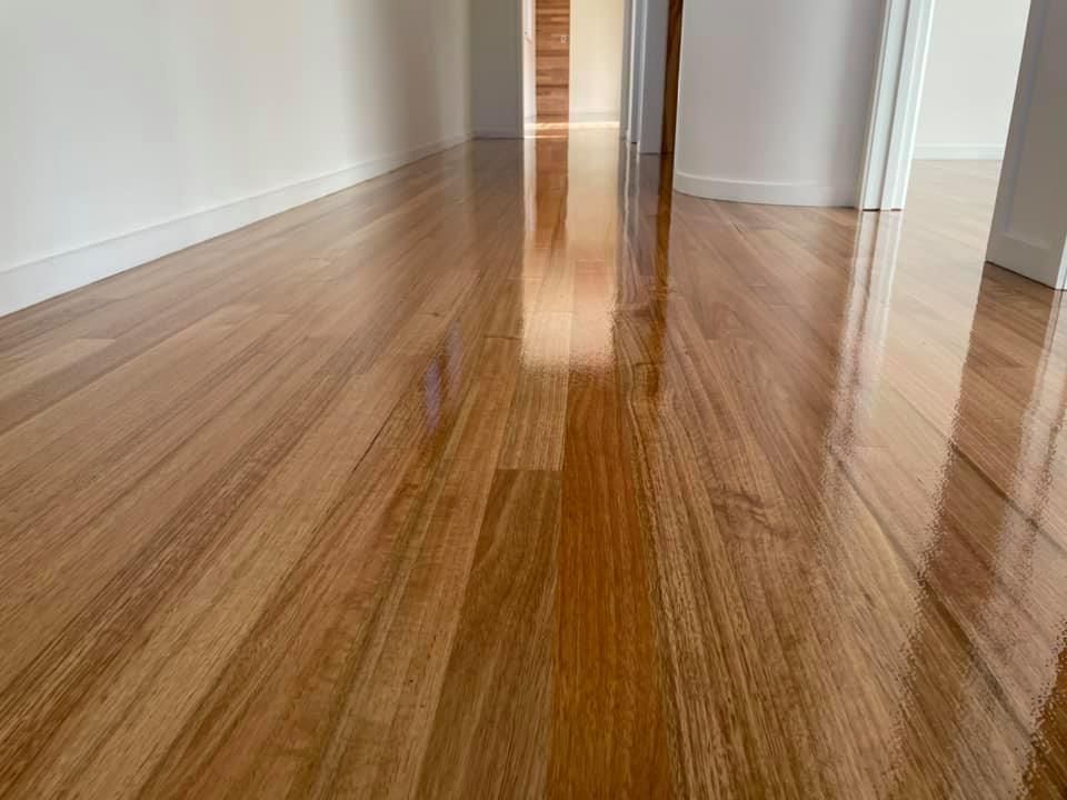 A Close-up of a Glossy, Light-brown Polished Hardwood Floor — Finer Floors In Warrane, TAS
