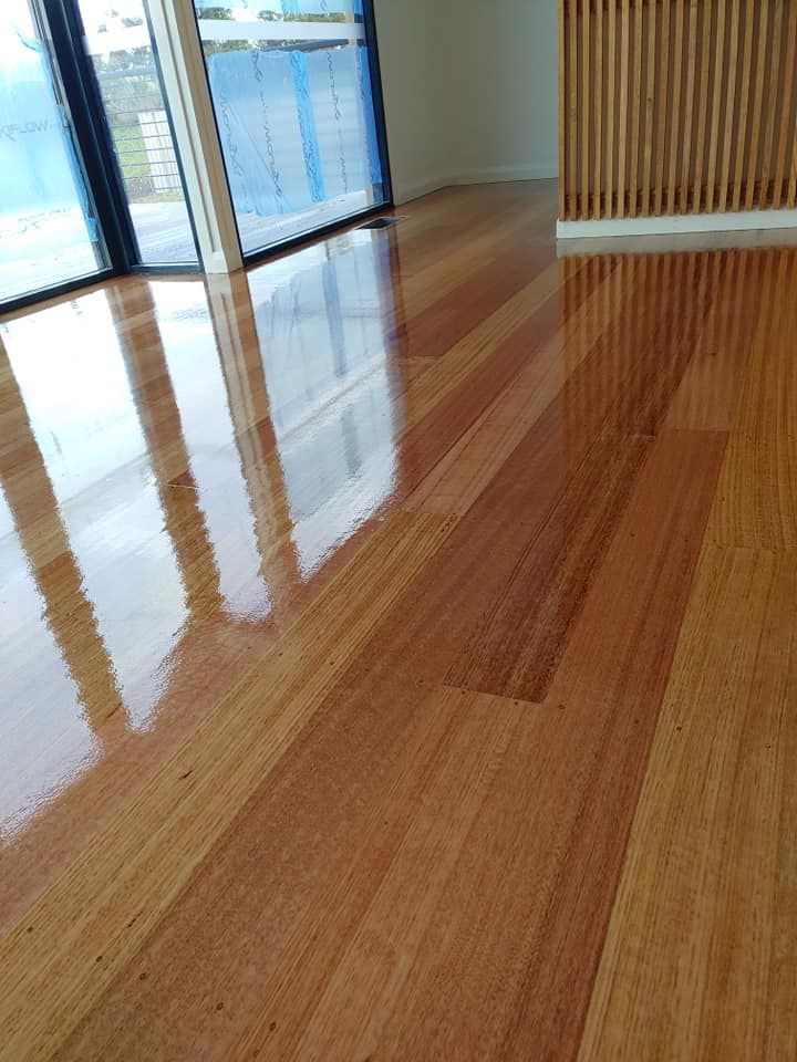 Shiny, Polished Light Brown Hardwood Floor With Visible Wood Grain — Finer Floors In Warrane, TAS