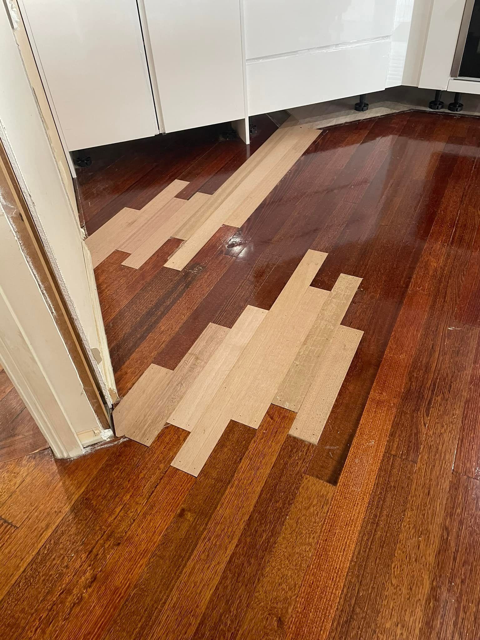 An Indoor View of a Wooden Floor Where a Section of Finished Reddish— Finer Floors In Warrane, TAS