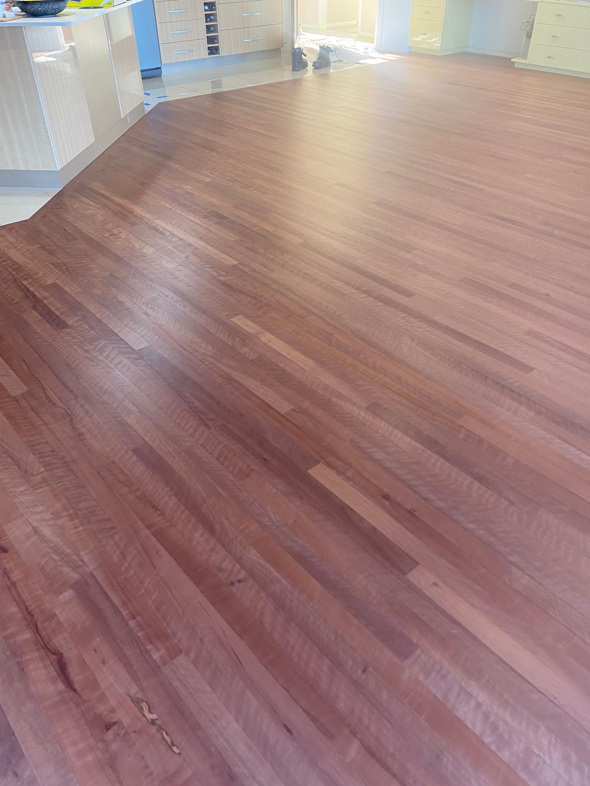 Empty polished wooden floor in a bright indoor hallway or room — Finer Floors In Cambridge, TAS