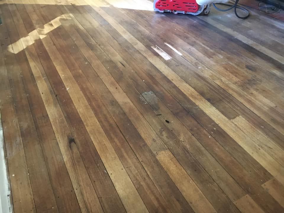 A Wooden Floor Partially Sanded to Show Raw Wood — Finer Floors In Warrane, TAS