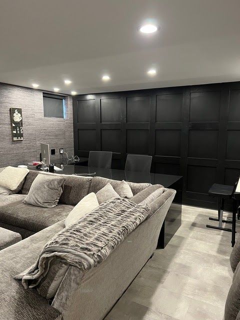 A living room with a couch , table and chairs.