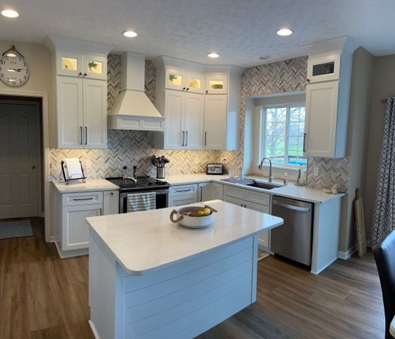 A kitchen with white cabinets and stainless steel appliances