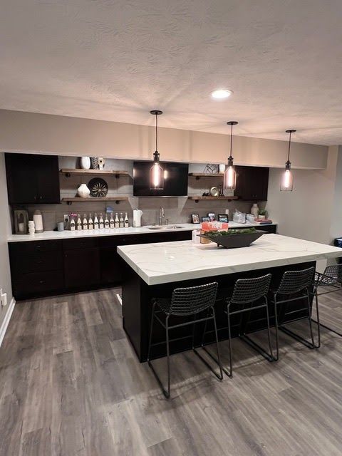 There is a large island in the middle of the kitchen.