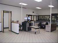 A large room with a lot of furniture and a metal detector.
