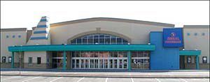 A large building with a lot of windows and a blue roof.