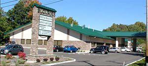 A building with a green roof and a sign that says woods.