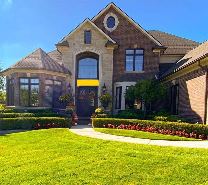 A home with a large front yard and landscaping.