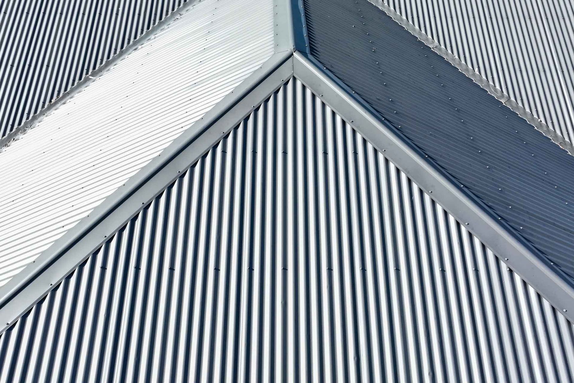 A close up of a metal roof with a diagonal striped pattern.