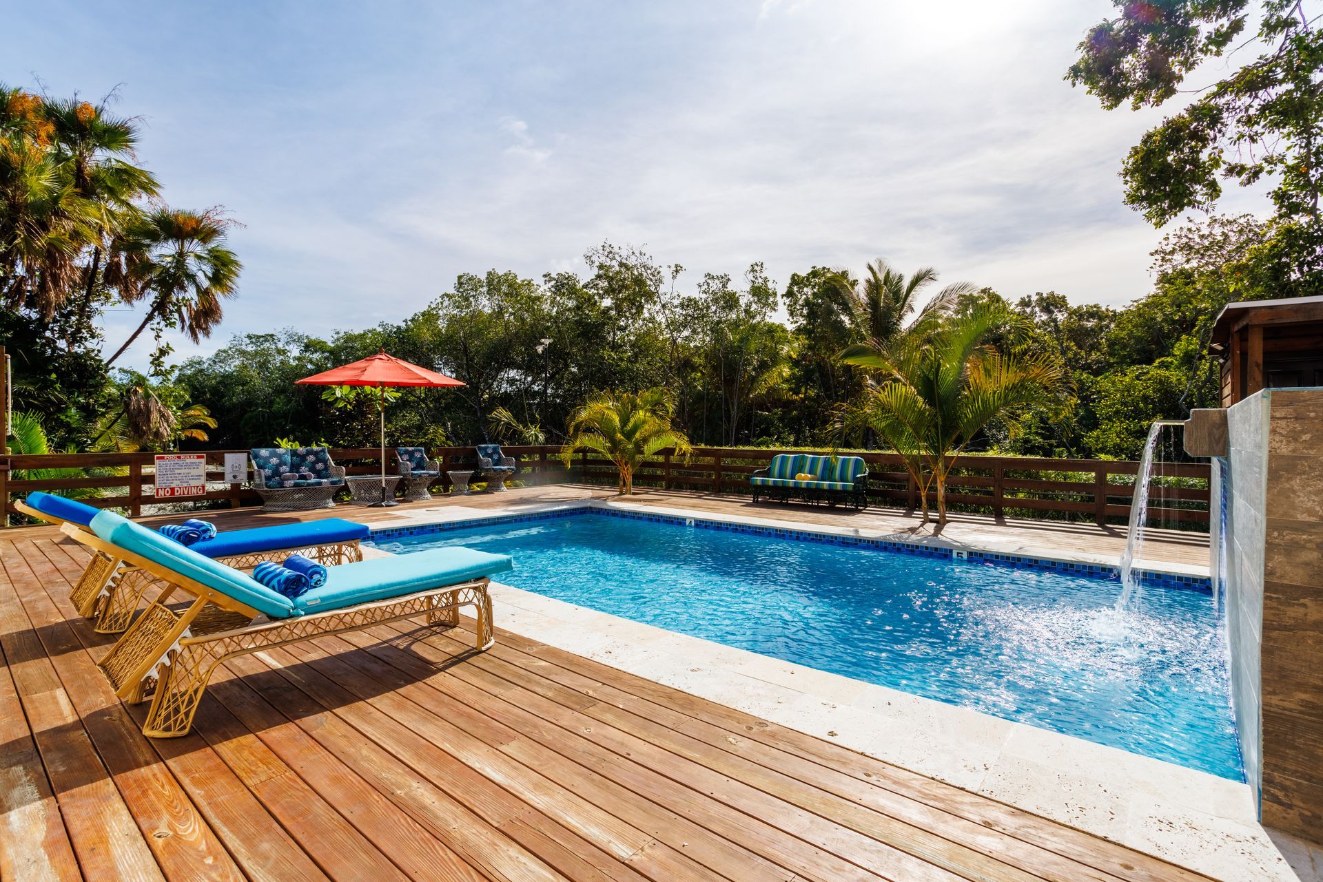 A large swimming pool with a waterfall in the background