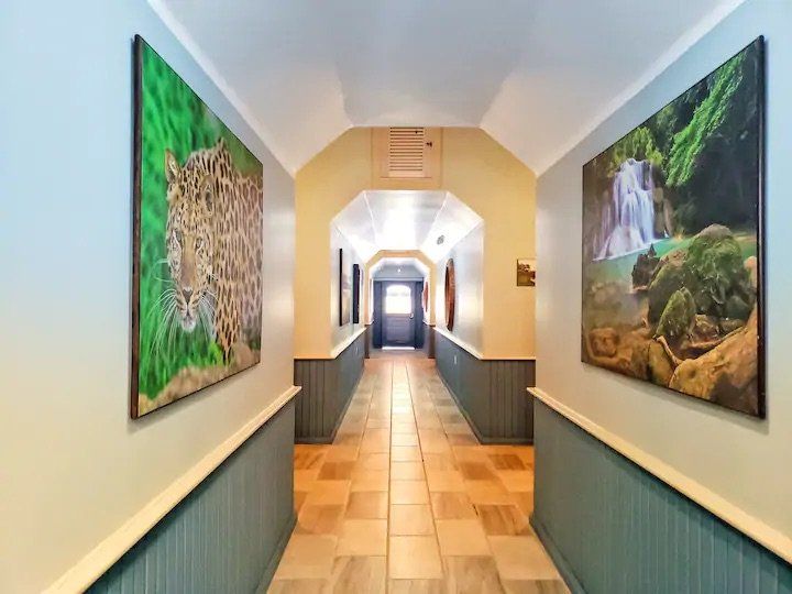 A long hallway with paintings on the walls