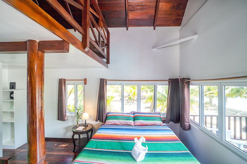 A bedroom with a king size bed and a wooden ceiling.