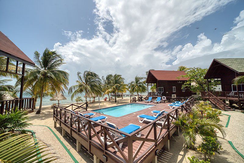 There is a large swimming pool in the middle of the beach.