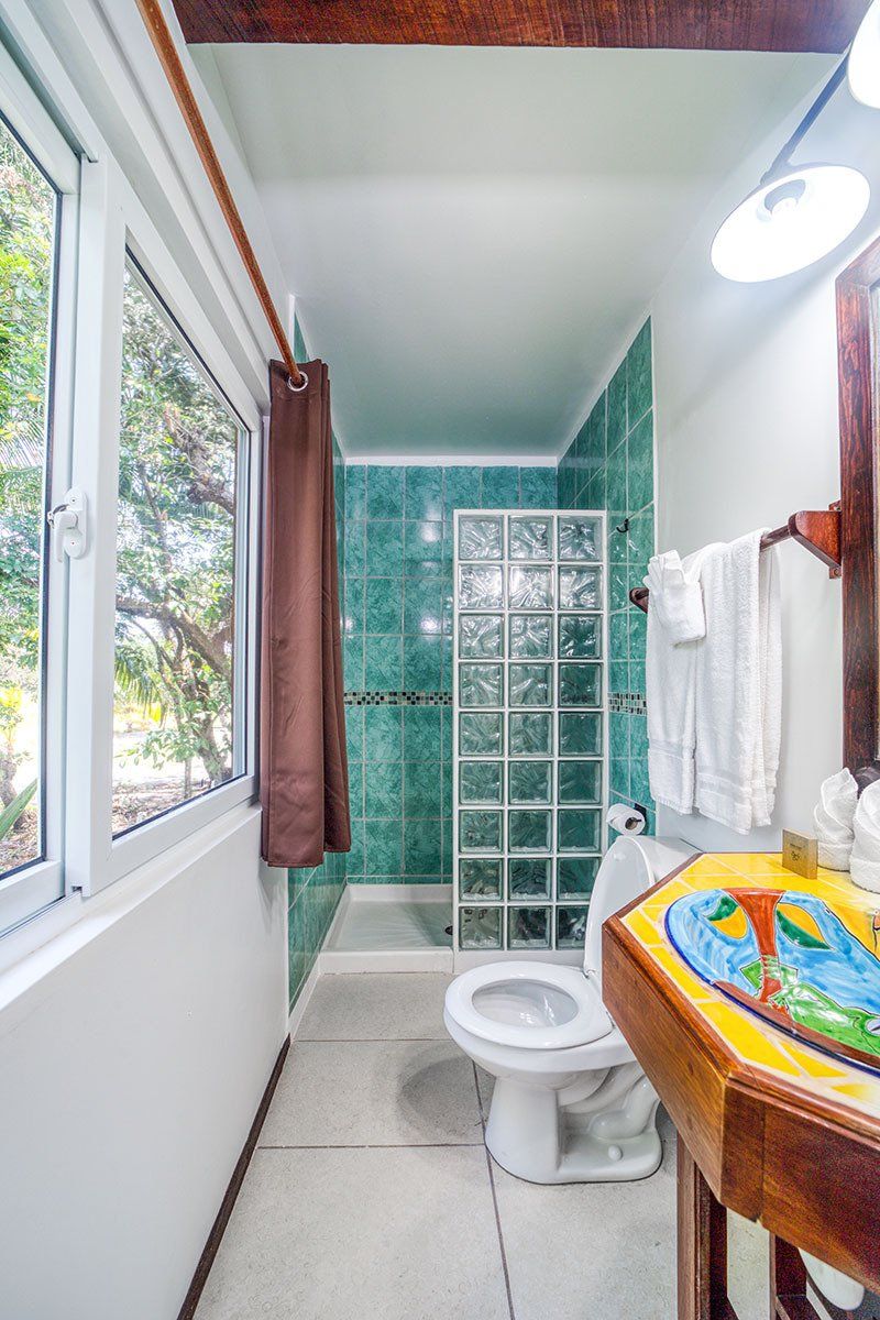 A bathroom with a toilet , sink , and shower.