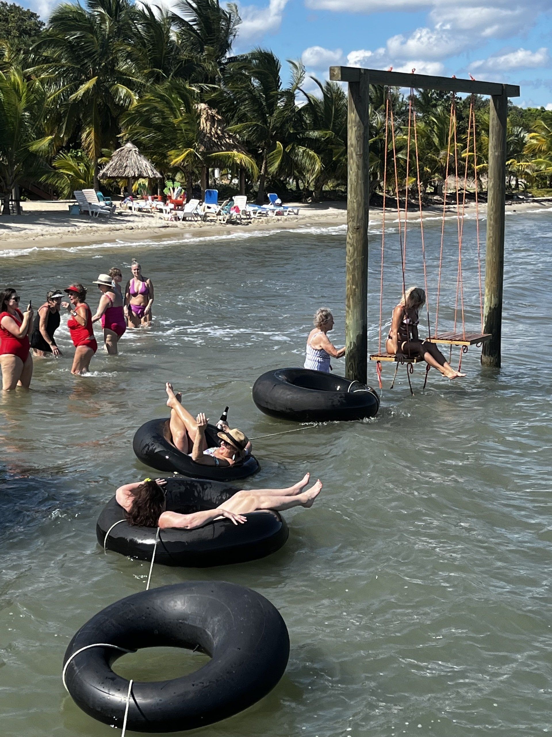 A group of people are floating on inner tubes in the water.