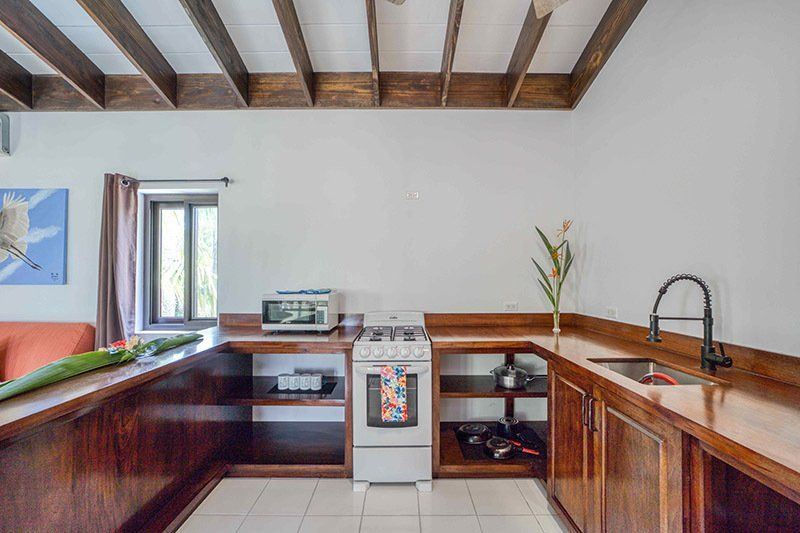 A kitchen with a stove , sink , and microwave.