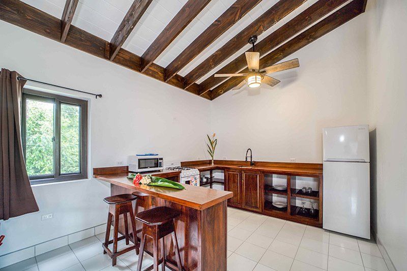 A kitchen with a ceiling fan and a refrigerator.
