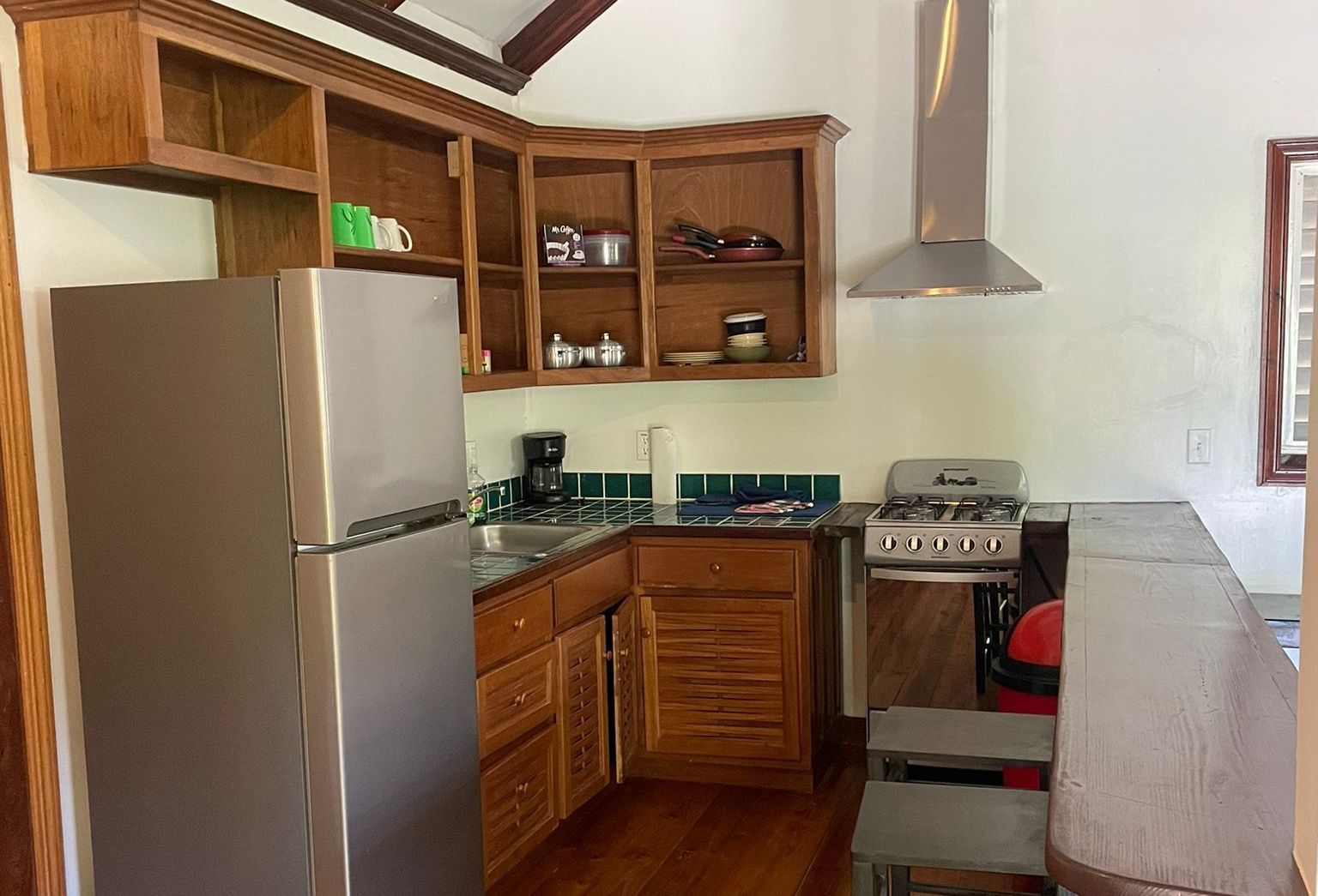 A kitchen with stainless steel appliances and wooden cabinets