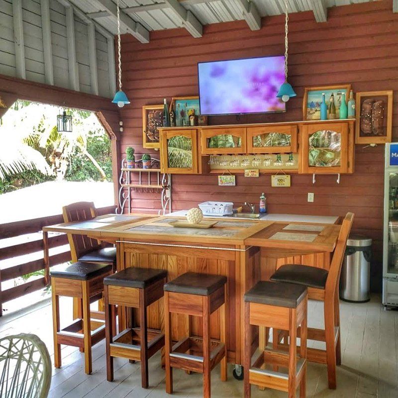 A bar with stools and a tv above it