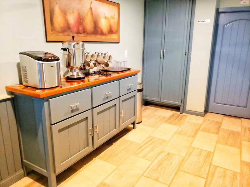 A kitchen with a buffet table and a picture on the wall.
