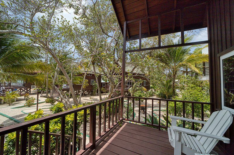 There is a chair on the balcony of a house.