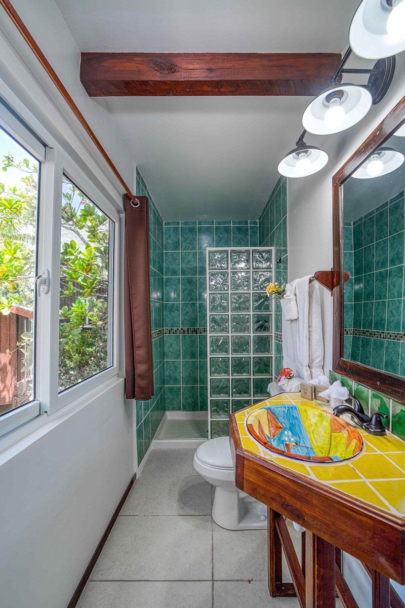 A bathroom with a sink , toilet and shower.