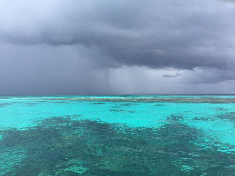 A storm is coming over the ocean with a lot of clouds.