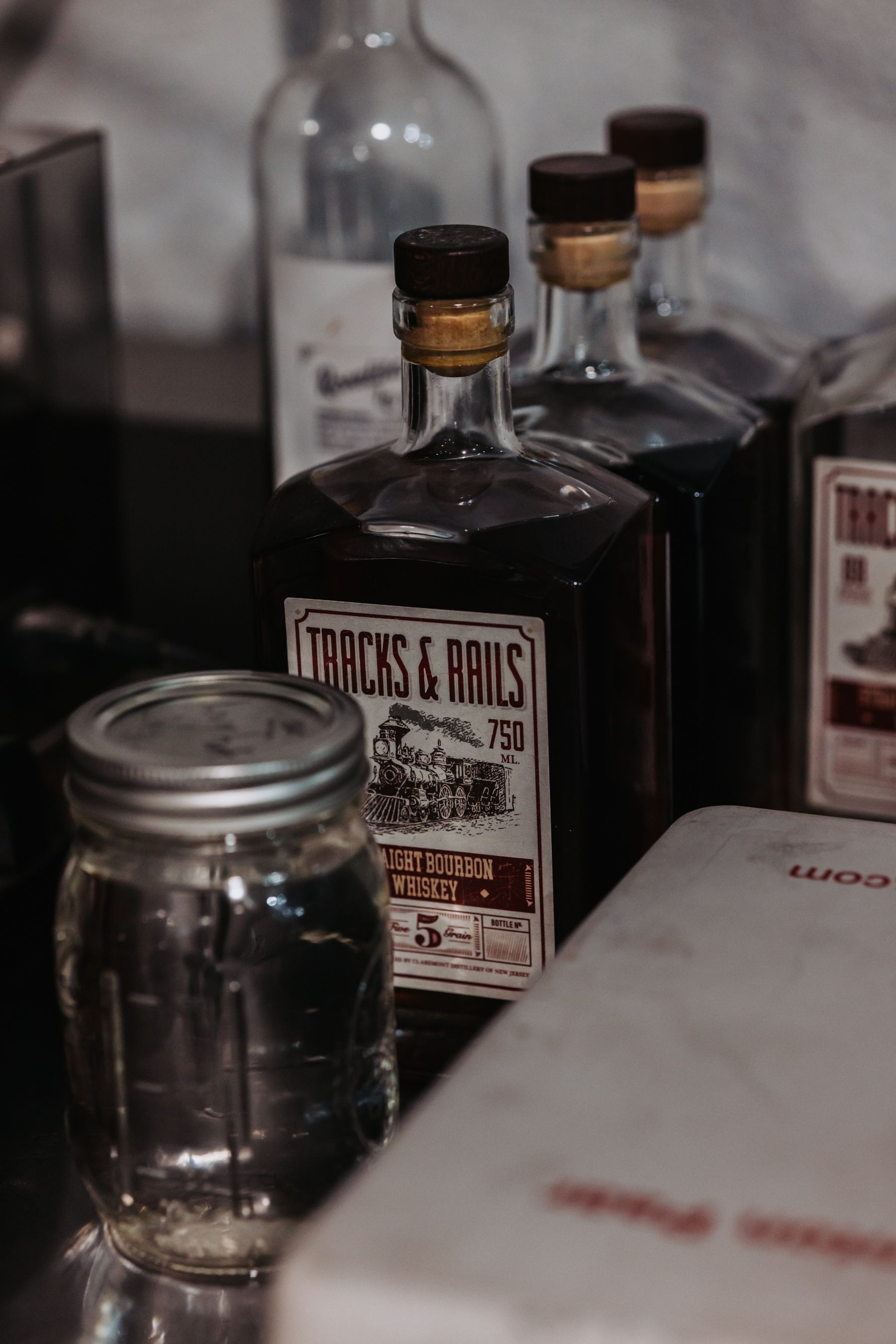 Bottles of dark liquid with labels, including 