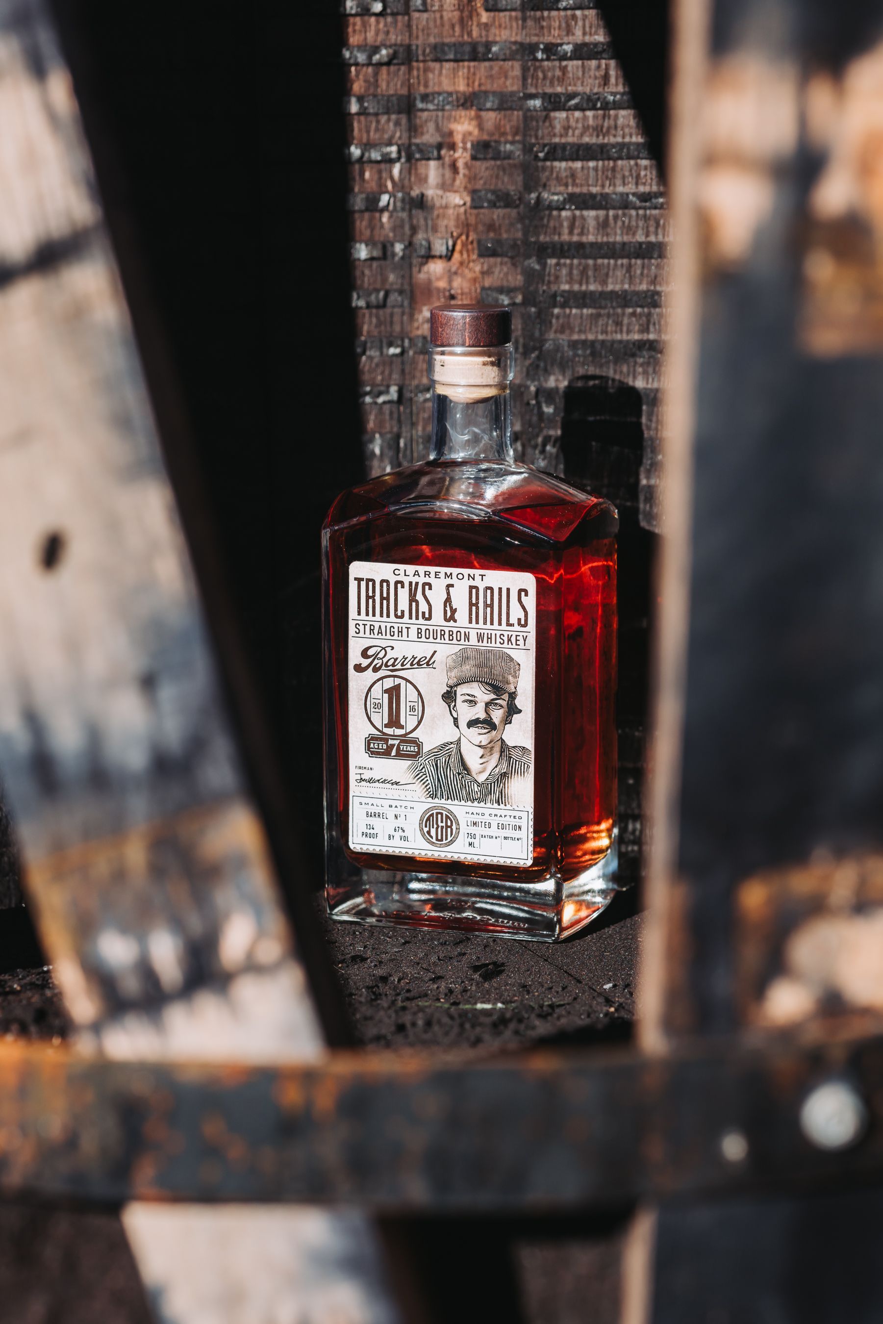 Bottle of amber-colored liquor with label “Fables & Fables,” set against a dark, wooden background.