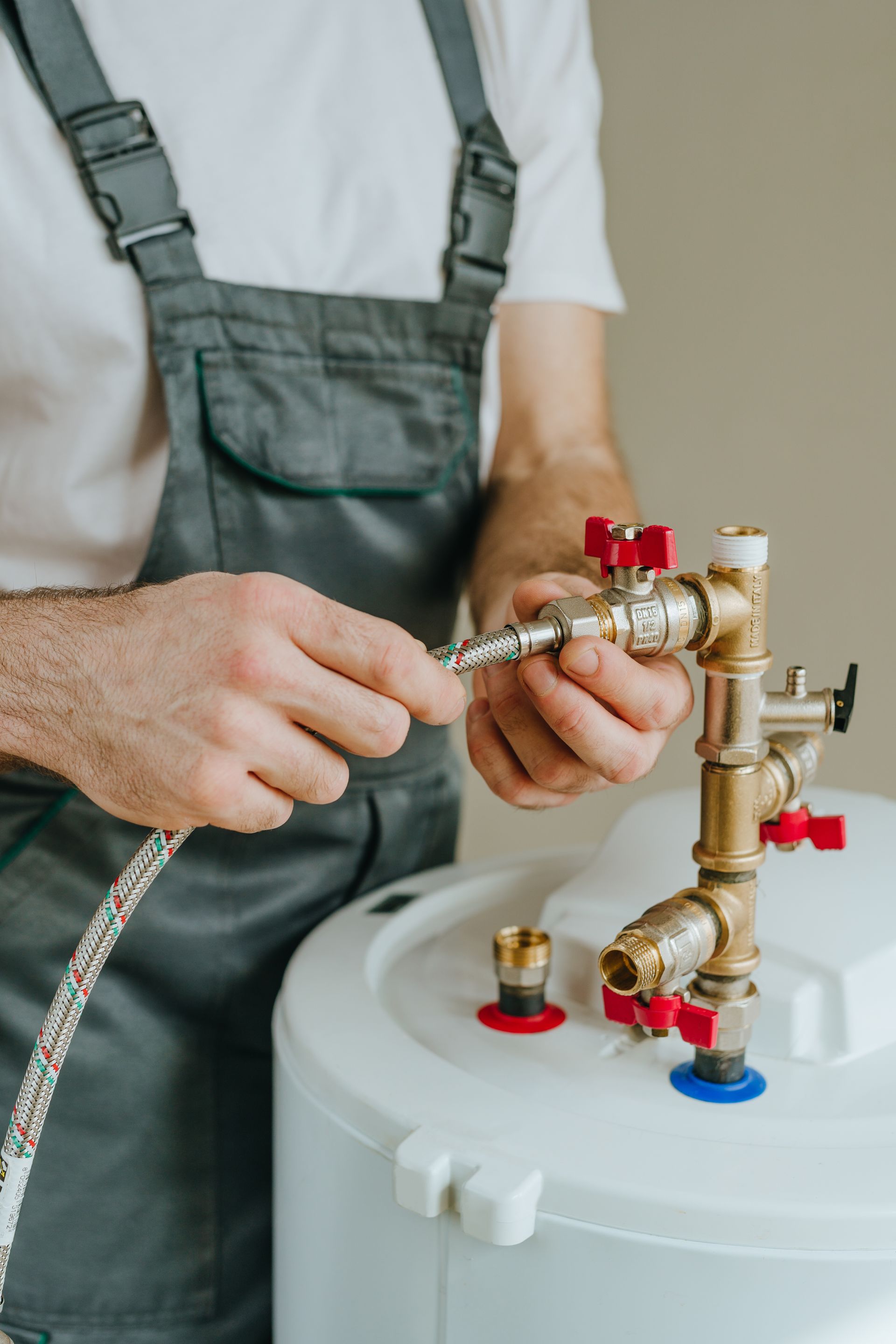 Water flowing down a stainless steel kitchen sink drain with a garbage disposal.