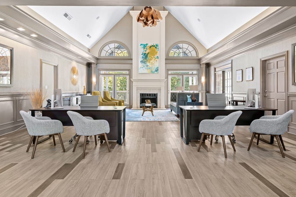 a large room with tables and chairs in it and a fireplace at Marquis on Edwards Mill in Raleigh, NC.