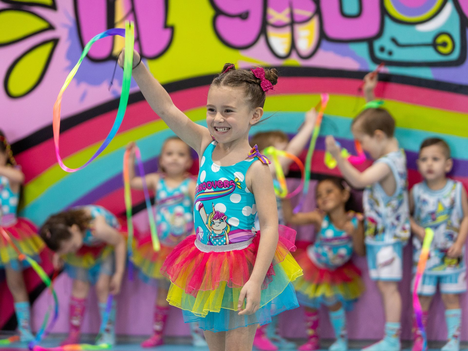 young girl posing confidently in a stylish dance outfit.
