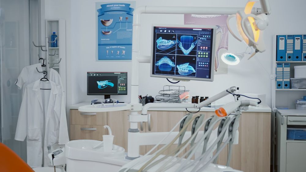 A dental office with a dental chair and a computer monitor.