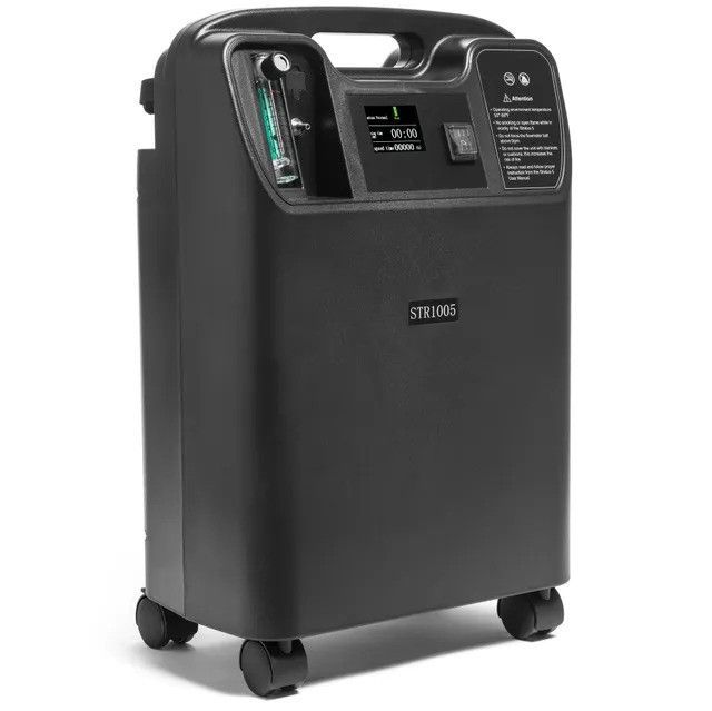 A black oxygen concentrator with wheels on a white background.