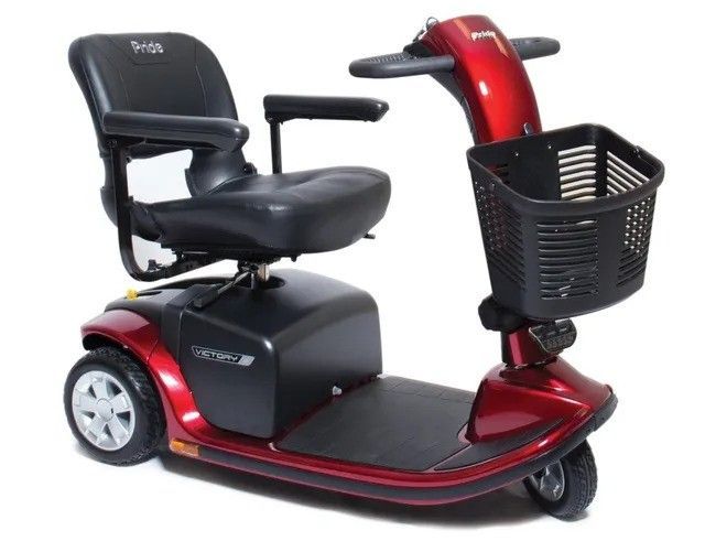 A red mobility scooter with a basket attached to it