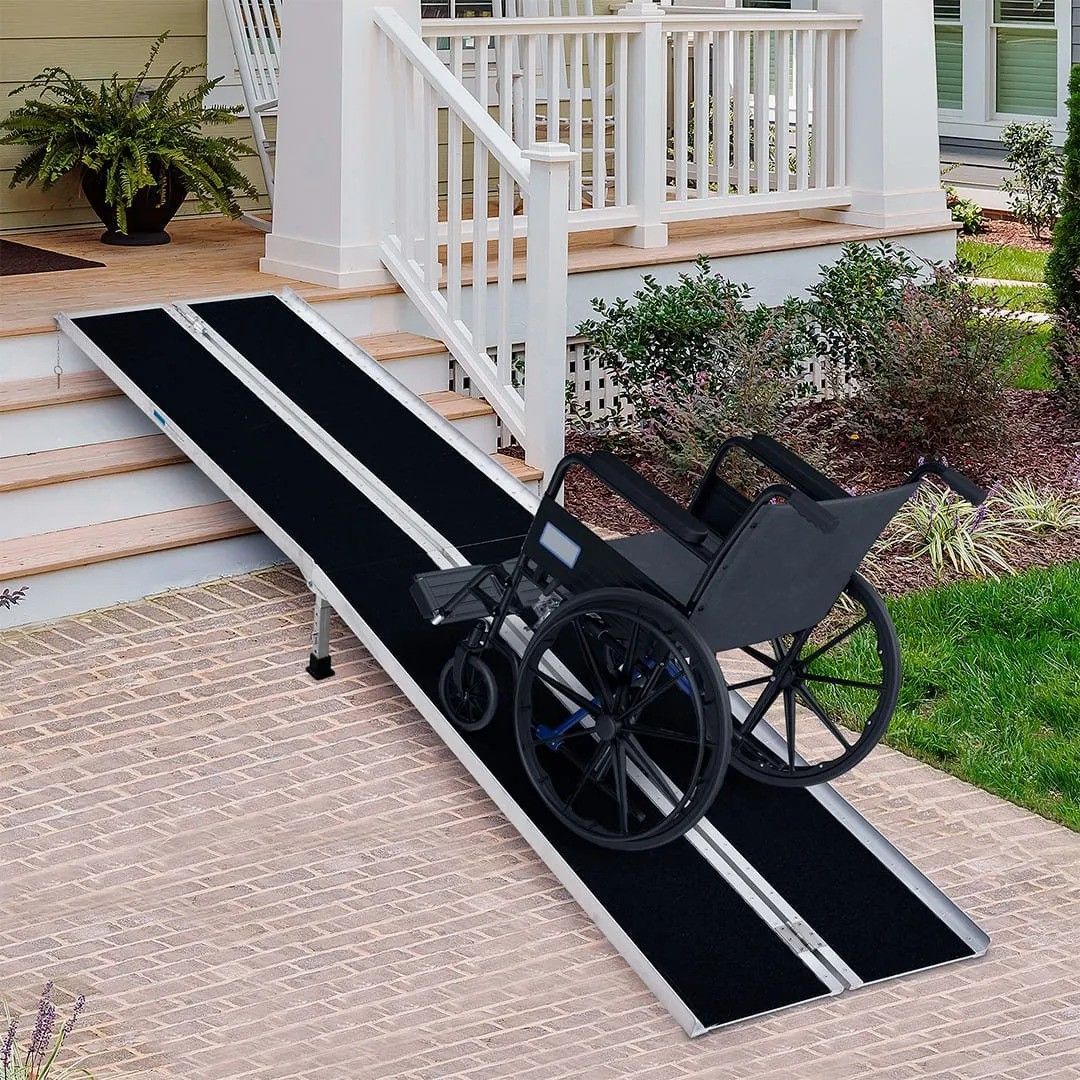 A wheelchair is going down a ramp in front of a house.