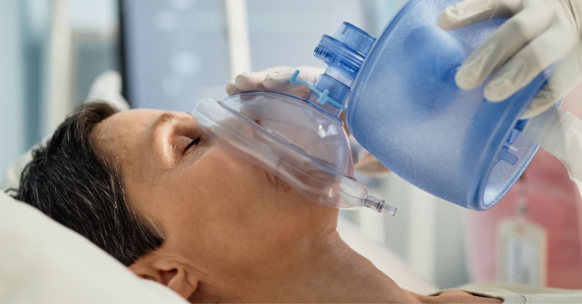 Patient receiving oxygen therapy using a medical oxygen mask to support breathing