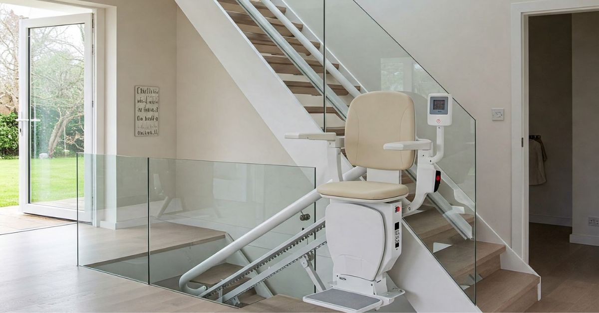 Stairlift installation on a contemporary staircase with glass railing for mobility access.