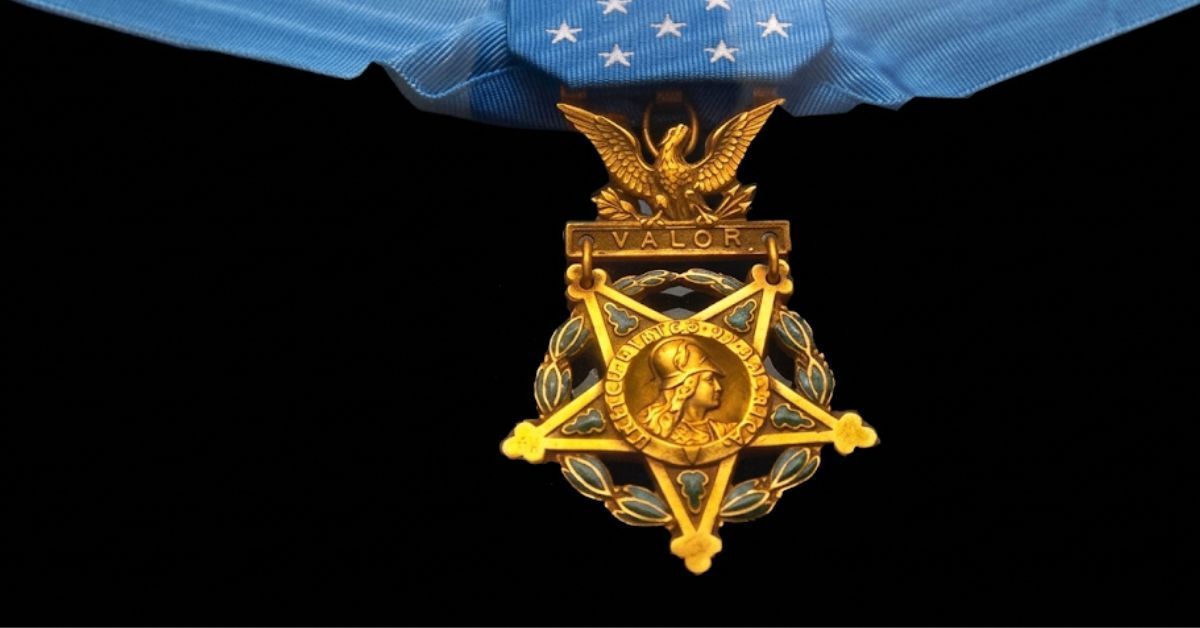 A detailed close-up of the Navy version of the Medal of Honor, showing the gold star with the profile of Minerva, the anchor, and the