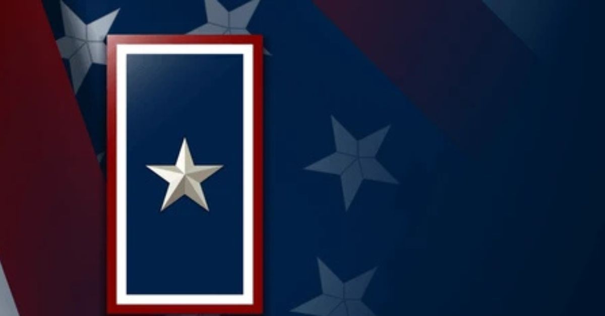 A wide view of a vertical blue banner with a centered silver star in a red-and-white frame, logicial