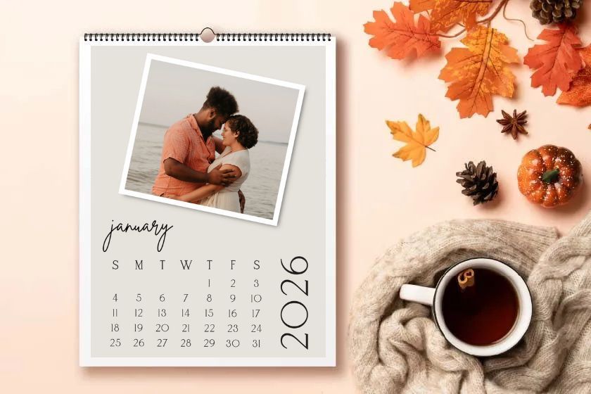A calendar with flowers on a wooden table