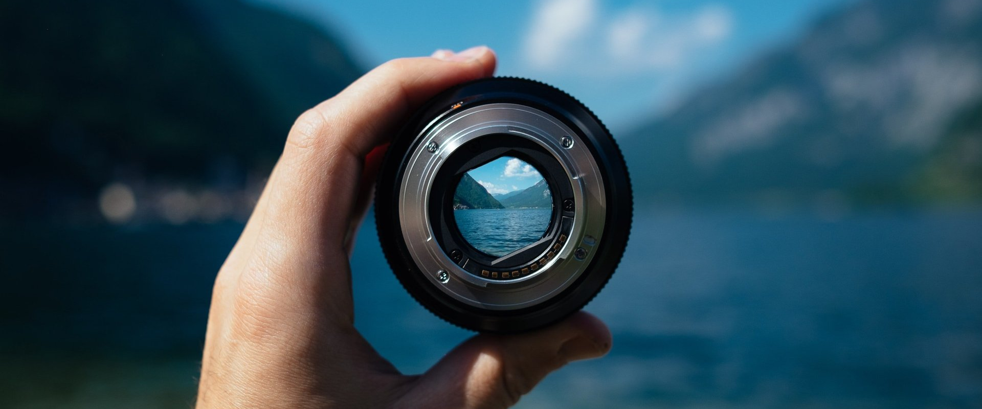 Viewing a mountain lake through a loupe