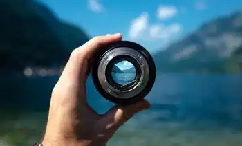 Viewing a mountain lake through a loupe